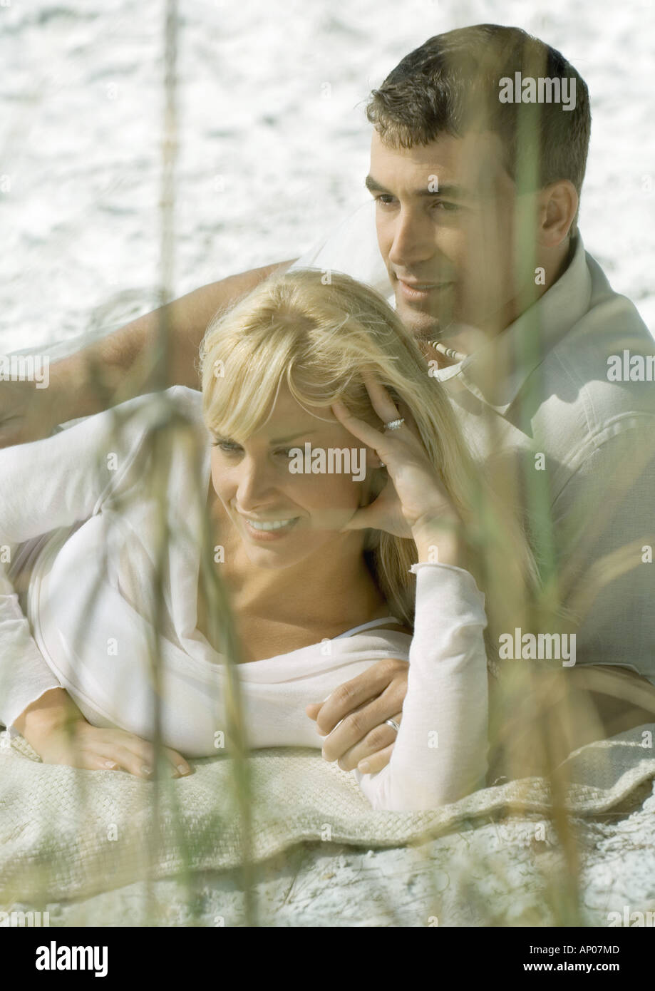 Couple lying on beach Stock Photo