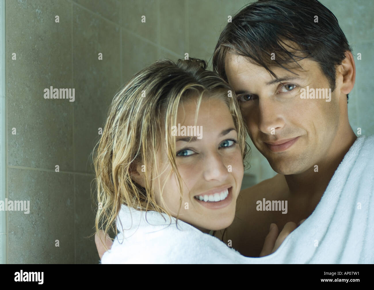 Couple sharing towel, looking at camera Stock Photo
