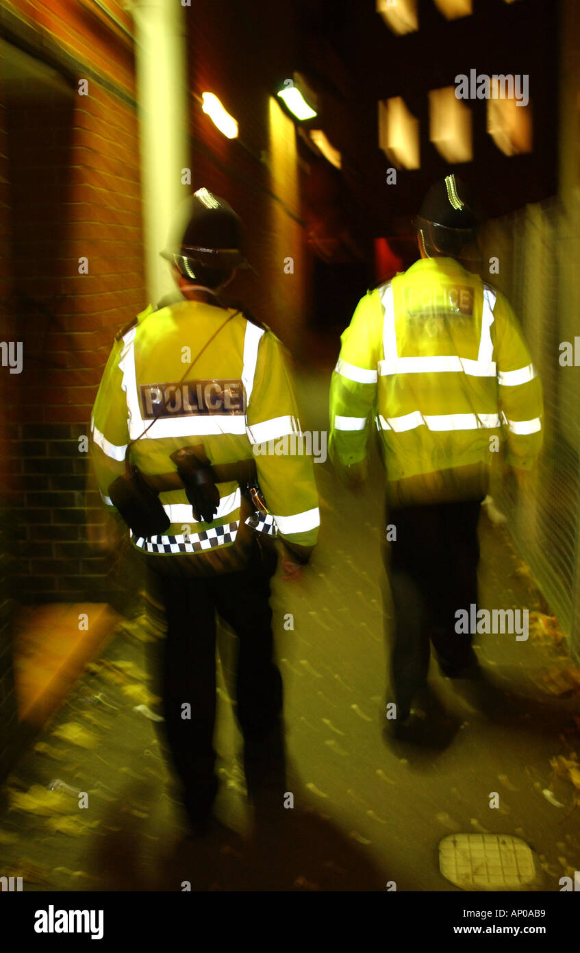 police officers on a town centre patrol at night Stock Photo