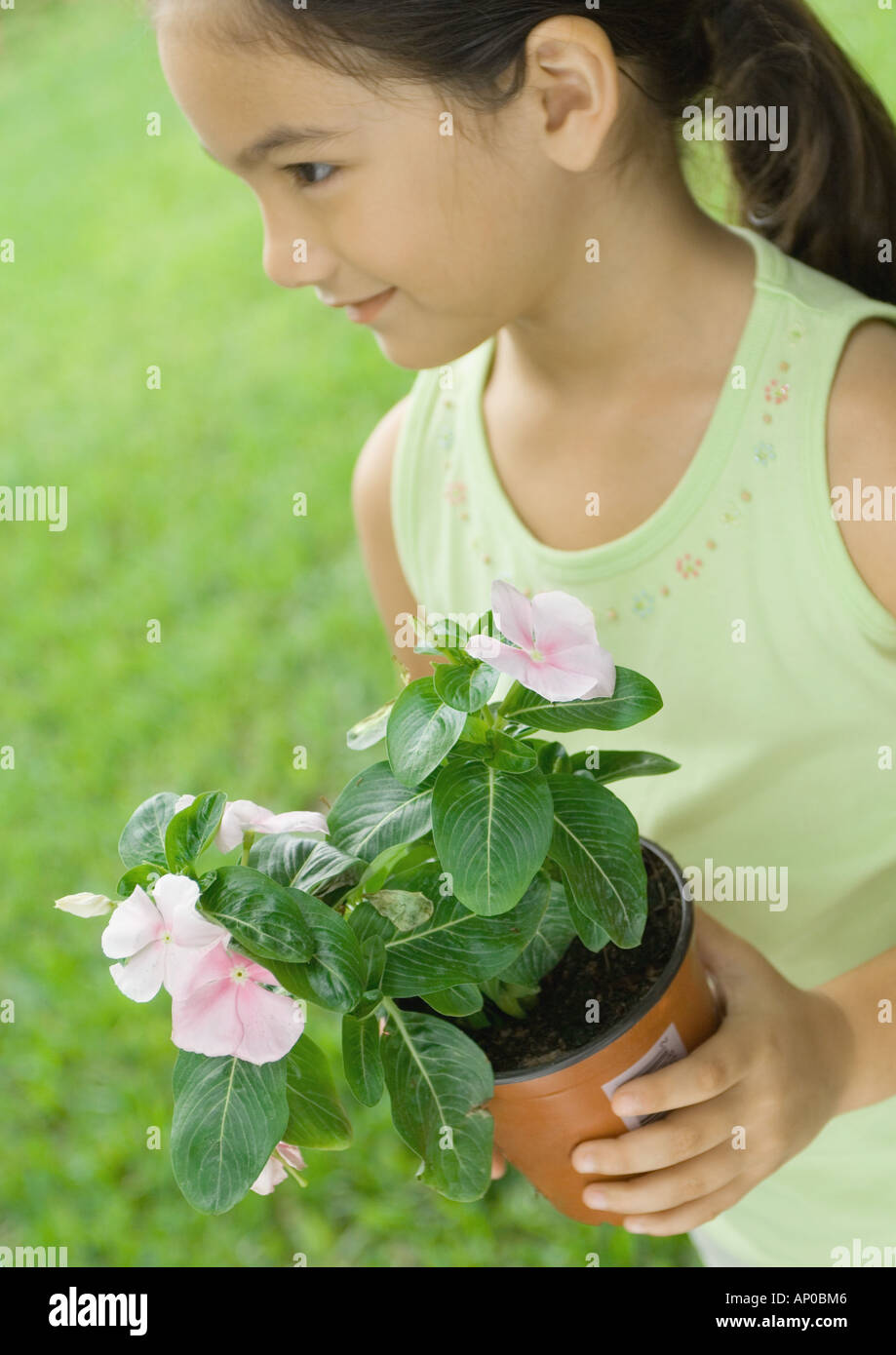 Girl holding potted plant Stock Photo