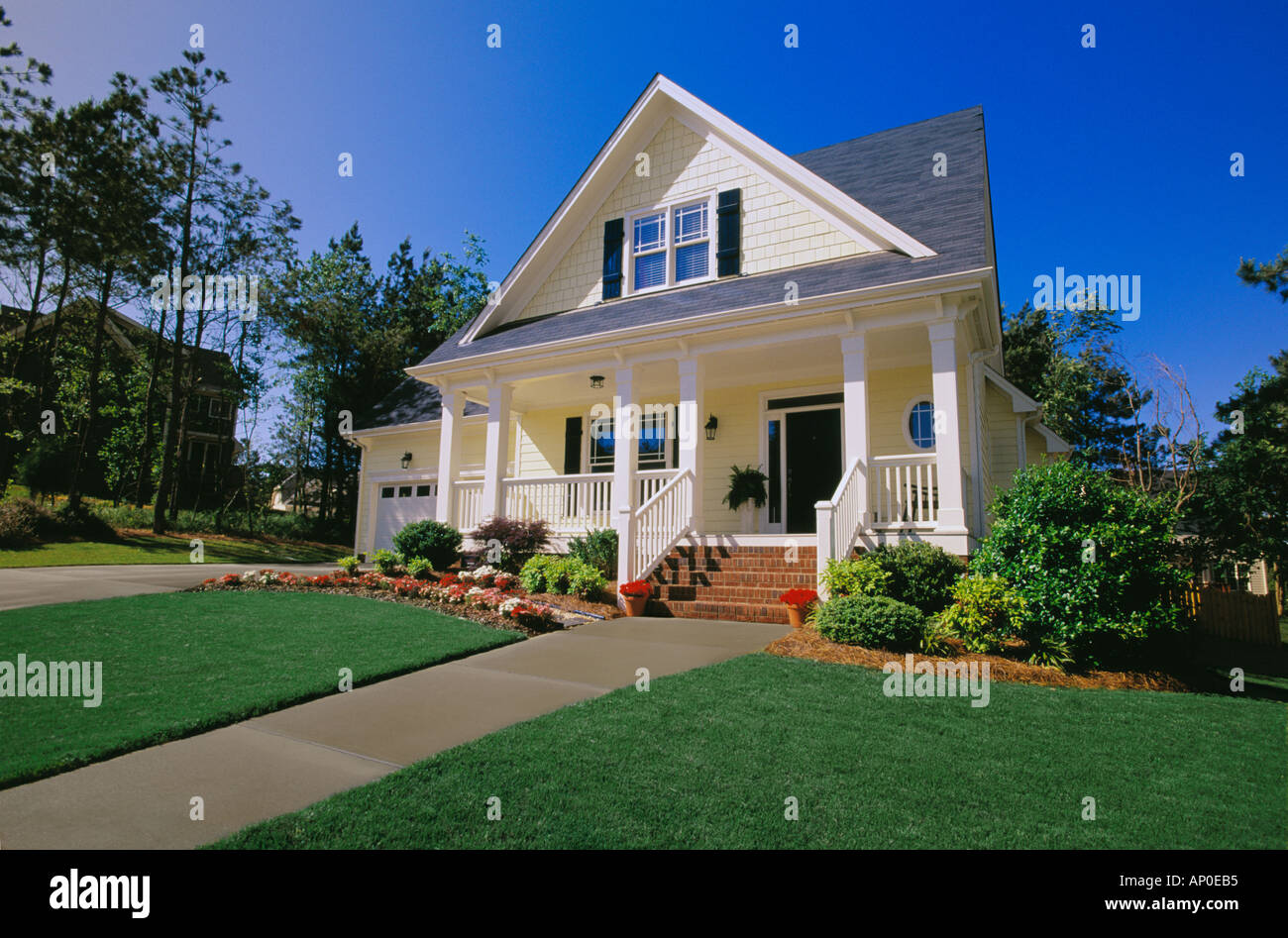 Small Two Story Yellow House With Black Shutters A Porch And Brick