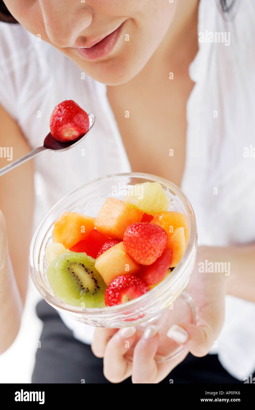Woman eating fruit salad Stock Photo Alamy