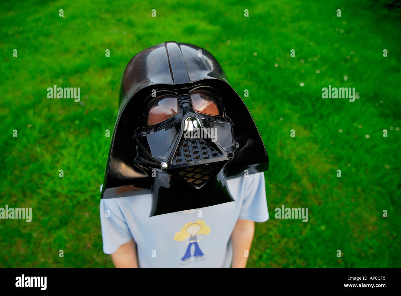 young girl wearing darth vader face mask Stock Photo