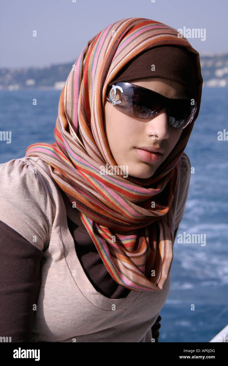 elegant saudi arabian girl posing with sunglasses and scarf Stock Photo