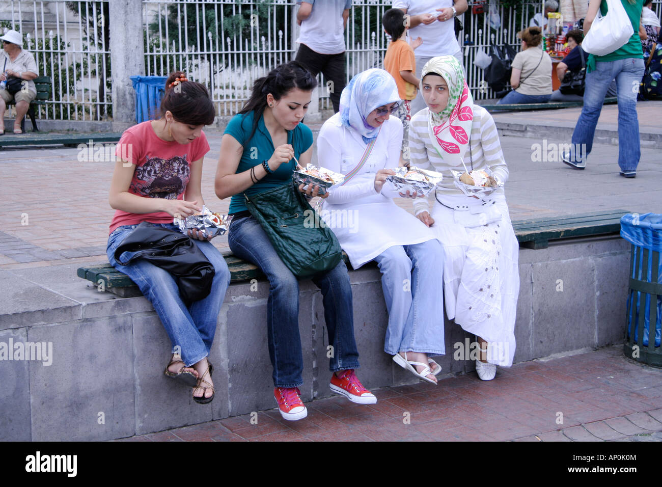 modern and traditional young turkish girls having take away food in istanbul turkey Stock Photo