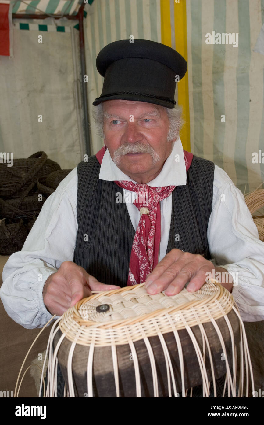 Frenchman in national costume weaving baskets at Cider Fayre Caudebec en Caux on River Seine near Lillebonne France Stock Photo