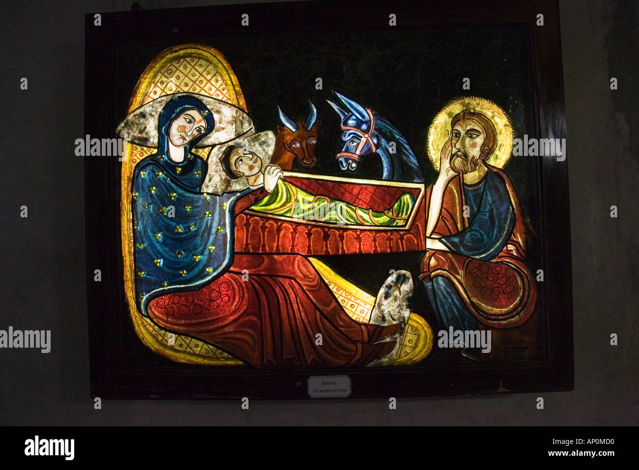The Nativity in stained glass inside the modern concrete underground Basilica of St Pie X Lourdes France Stock Photo
