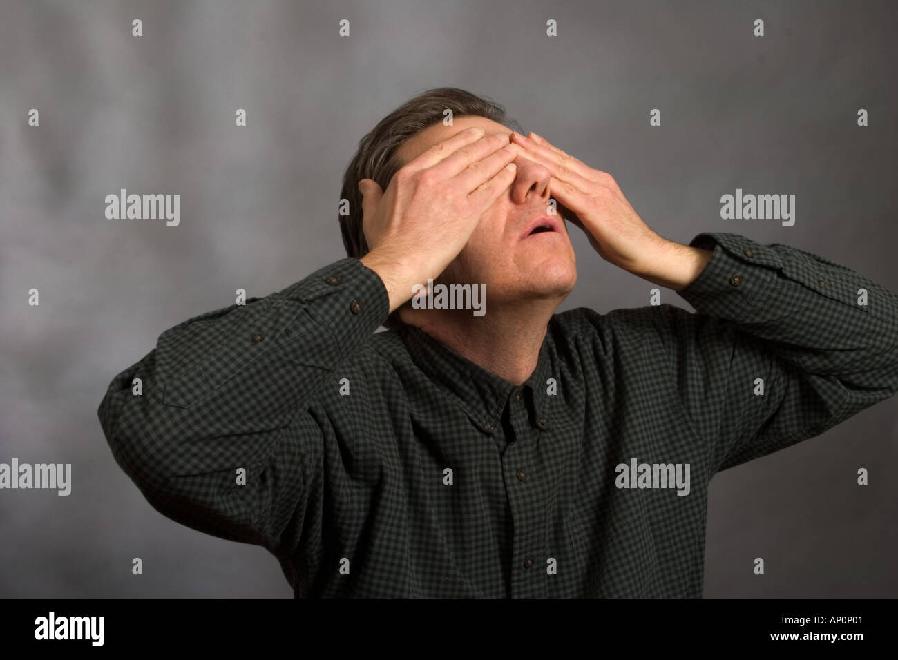 Man covering his eyes with his hands Model Released Stock Photo - Alamy