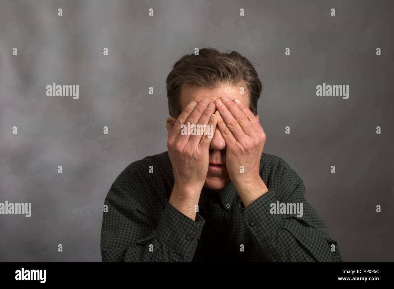 Man covering his eyes with his hands Model Released Stock Photo - Alamy