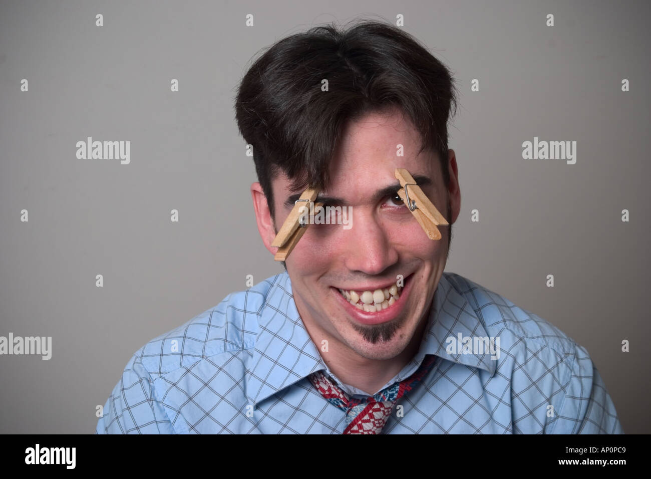 Young man with clothespins on his eyebrows Stock Photo Alamy