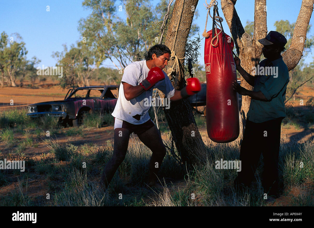 Denny und Paul boxing the sandbag, Fred Brophy's Boxing Troupe, Boulia, Simpson Desert, Australia Stock Photo