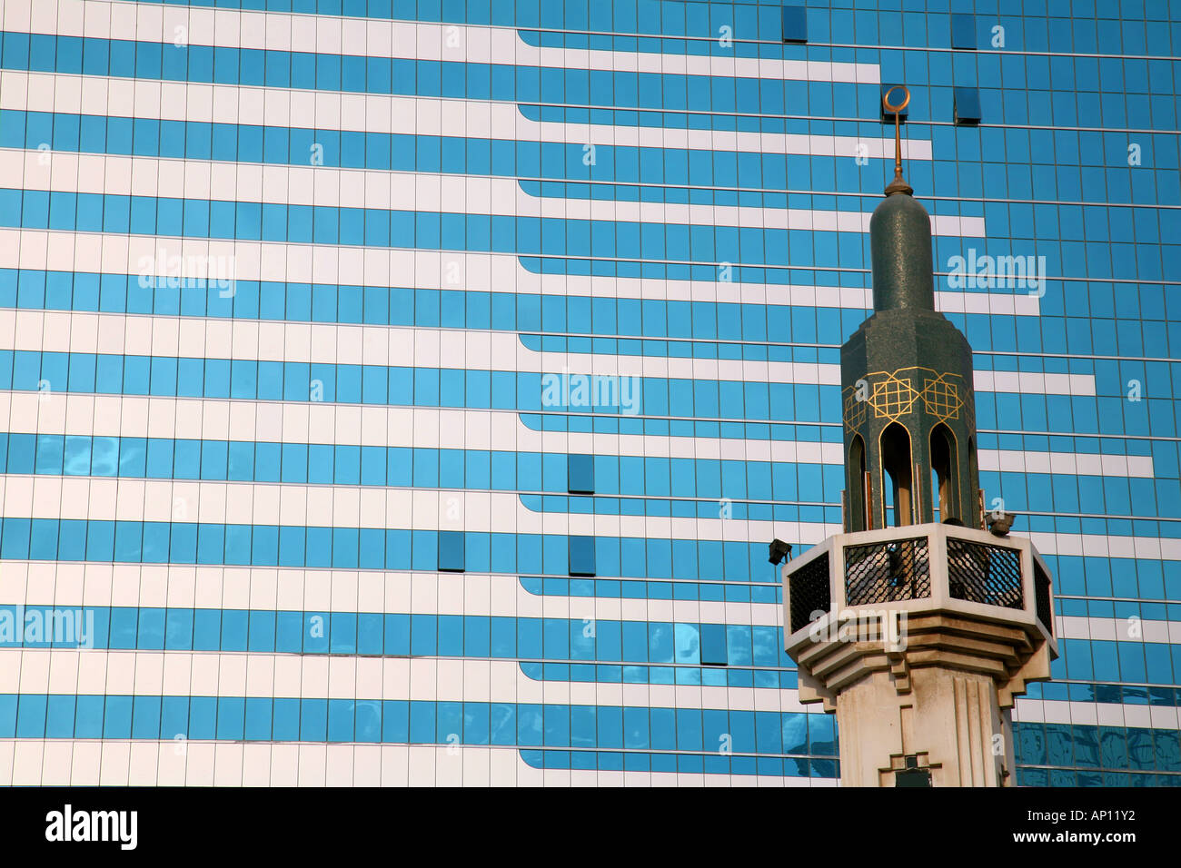 Minaret set against modern skyscrapers, Abu Dhabi, United Arab Emirates Stock Photo