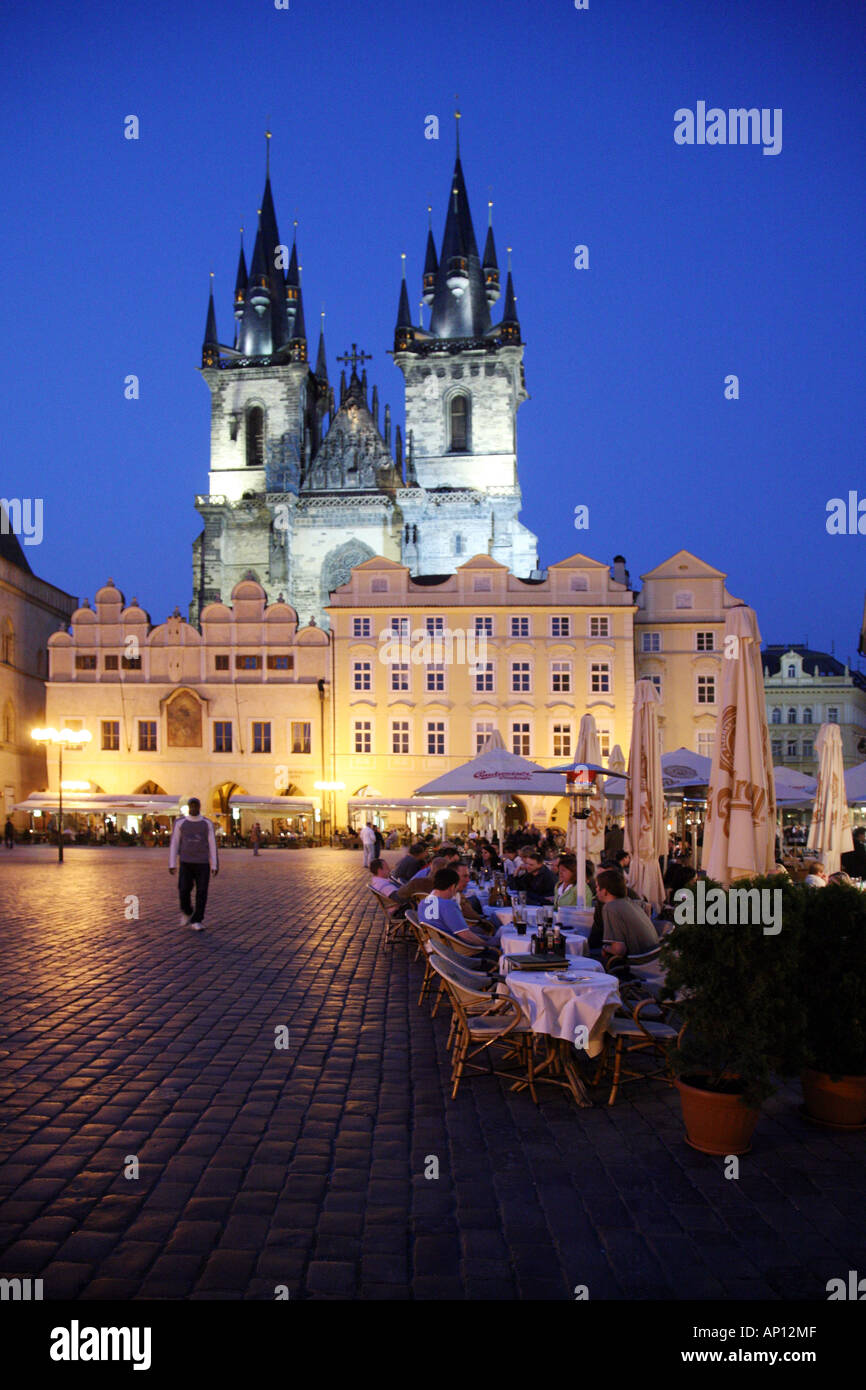 Tourists dining alfresco at a restaurant  in front of the Tyn Church at dusk, Old Town Square, Prague, Czechia Europe Stock Photo