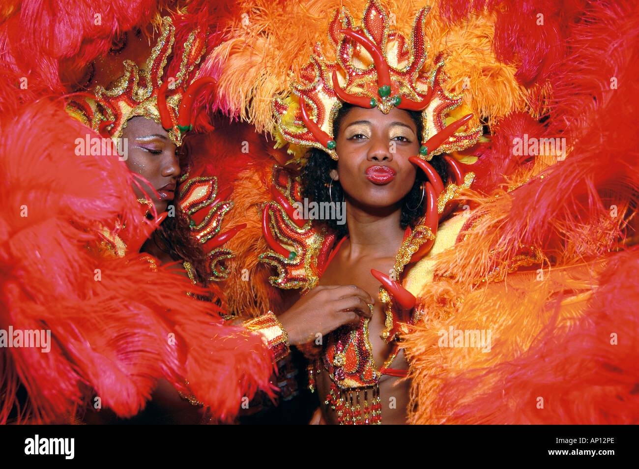 A member of one of the many Samba schools has finishing touches made to her costume at the start of the carnival parade in Rio Stock Photo