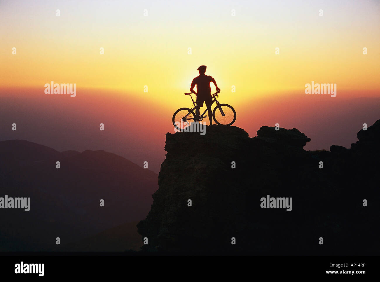 A person standing on the summit with his mountainbike, Andalusia, Spain Stock Photo