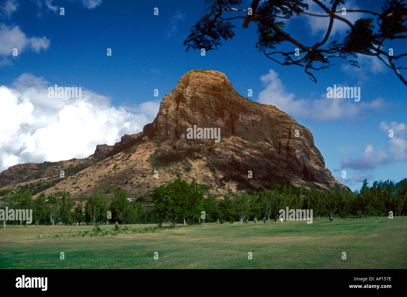Le Mourne geological monolith with white clouds billowing behind on peninsula Le Morne Brabant, island of Mauritius, Indian Ocean Stock Photo