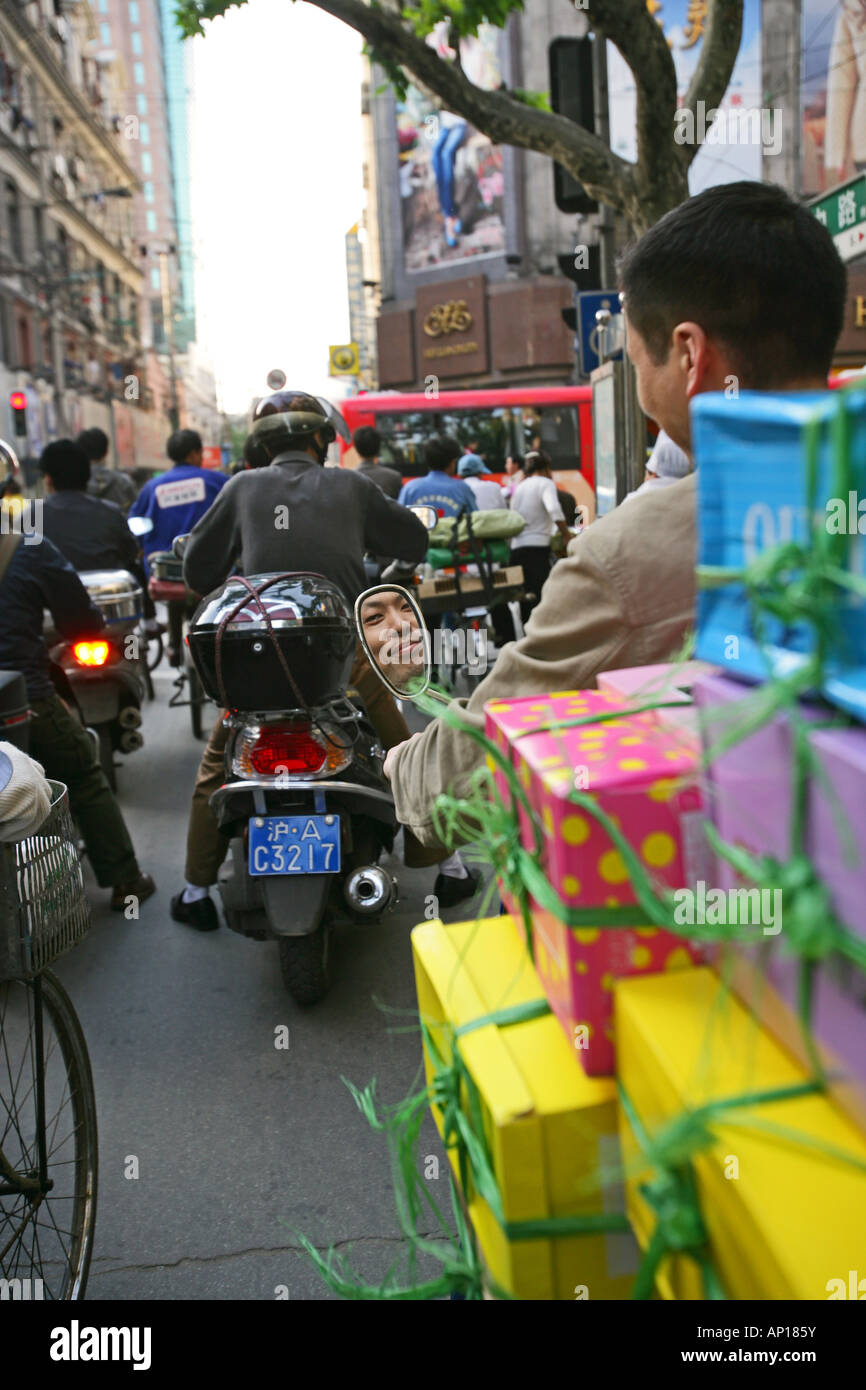 Traffic Shanghai, motorbike taxi, driver, courier, Motorradkurier, Motorradtaxi, Geschenke, presents, face in mirror, Spigelbild Stock Photo
