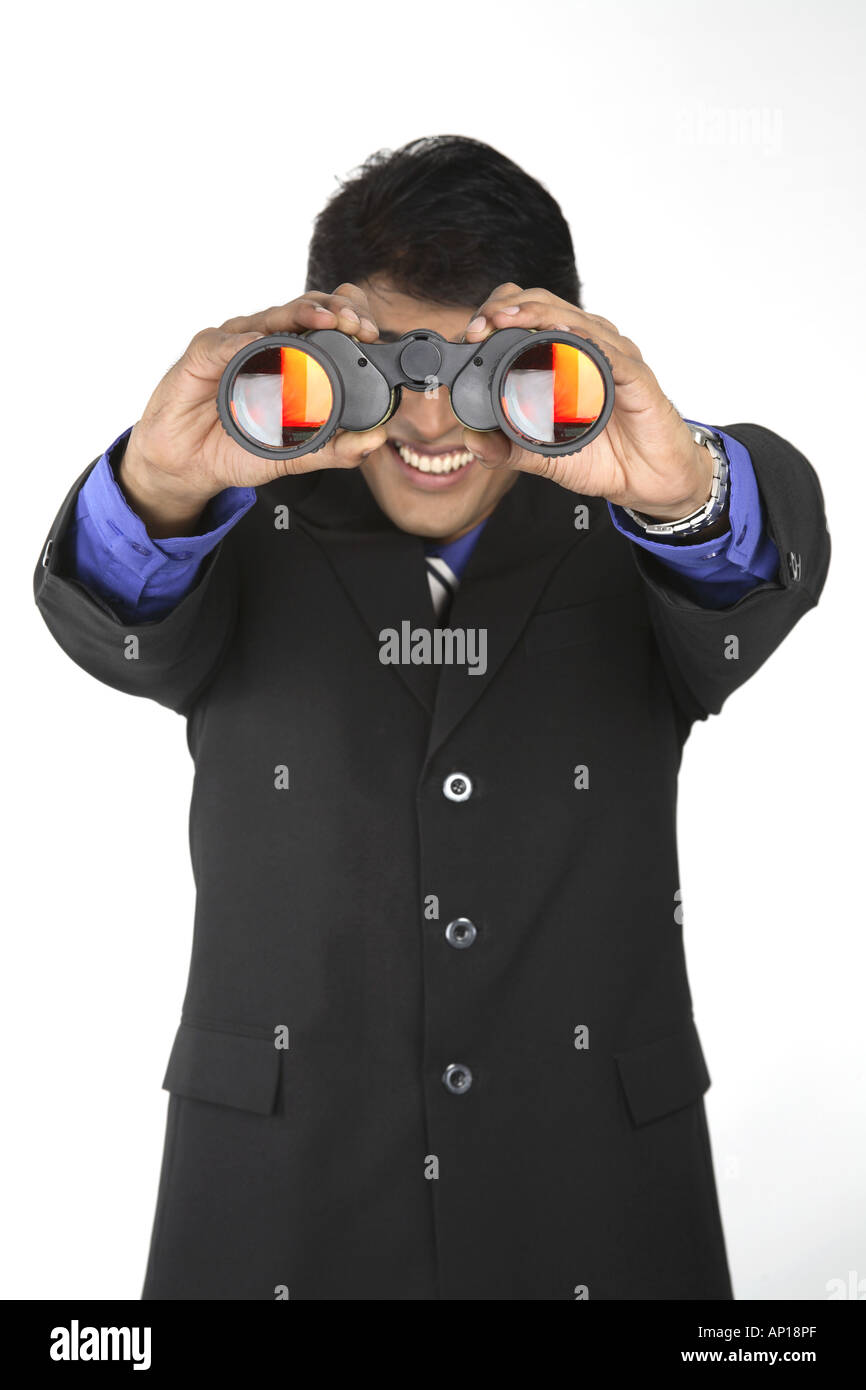 ANG200031 Executive holding binocular with both hands and looking Stock Photo
