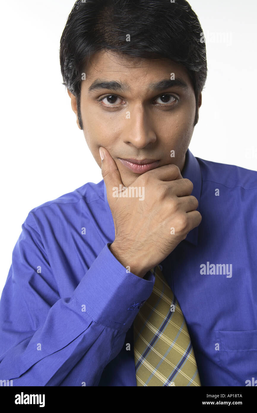 ANG200047 Executive resting on a chair thinking holding his chin Stock Photo