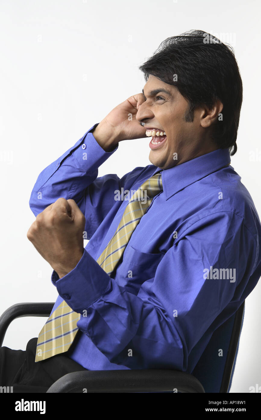 ANG200052 Executive talking on mobile smiling very happy confident Stock Photo
