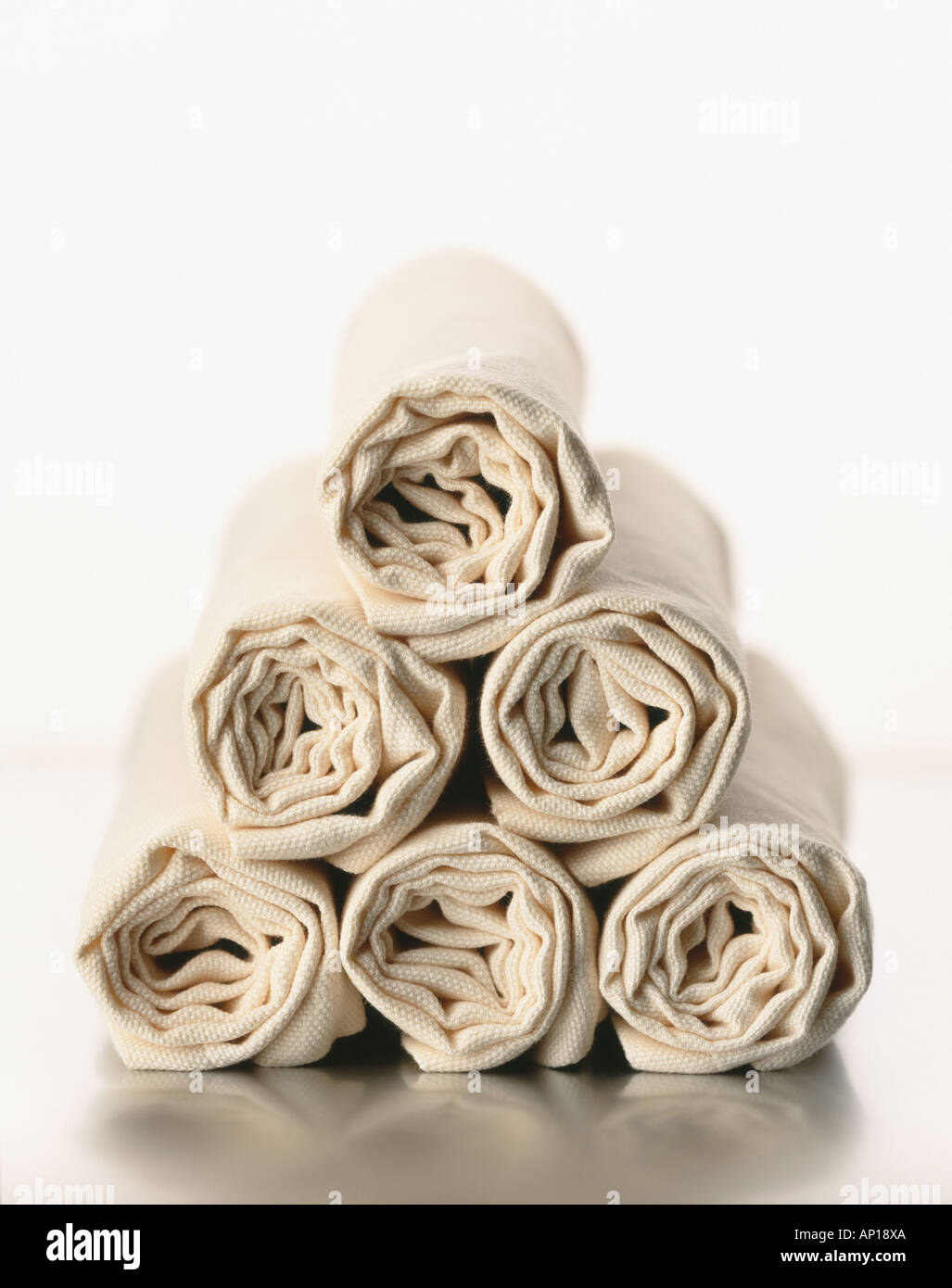 Six Cotton Napkins Cream Colour Rolled up on Top of Each Other Stock Photo