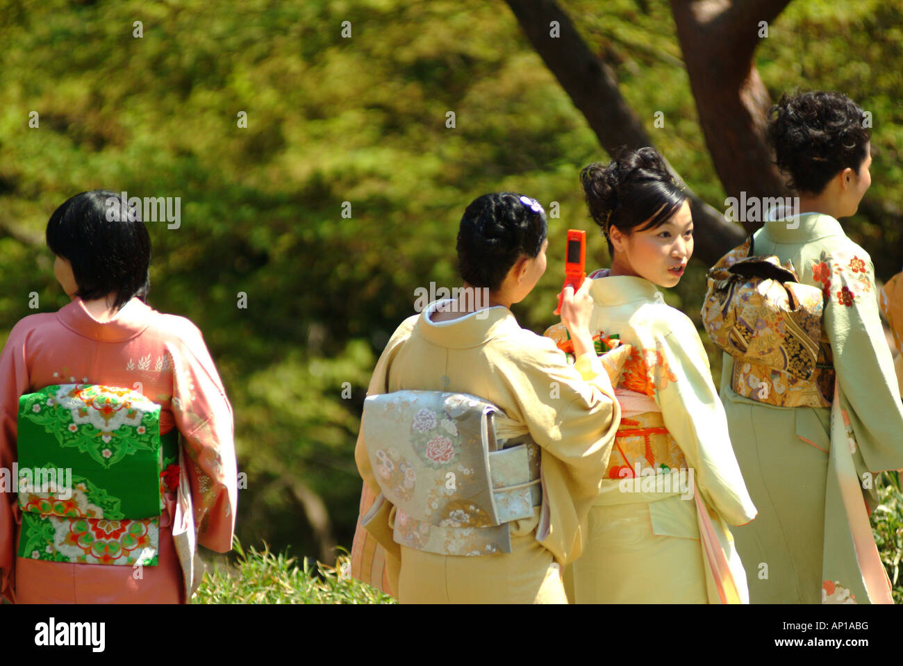 Four japanese women in kimonos, Happo-en Garden, Tokyo, Japan Stock Photo