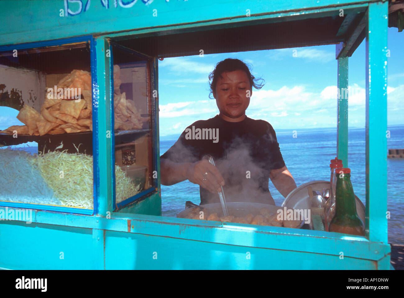 indonesian woman is preparing food, cookshop at waterfront, Bali, Indonesia, Asia, cooking, snack, water, exotic, mobile, mobili Stock Photo