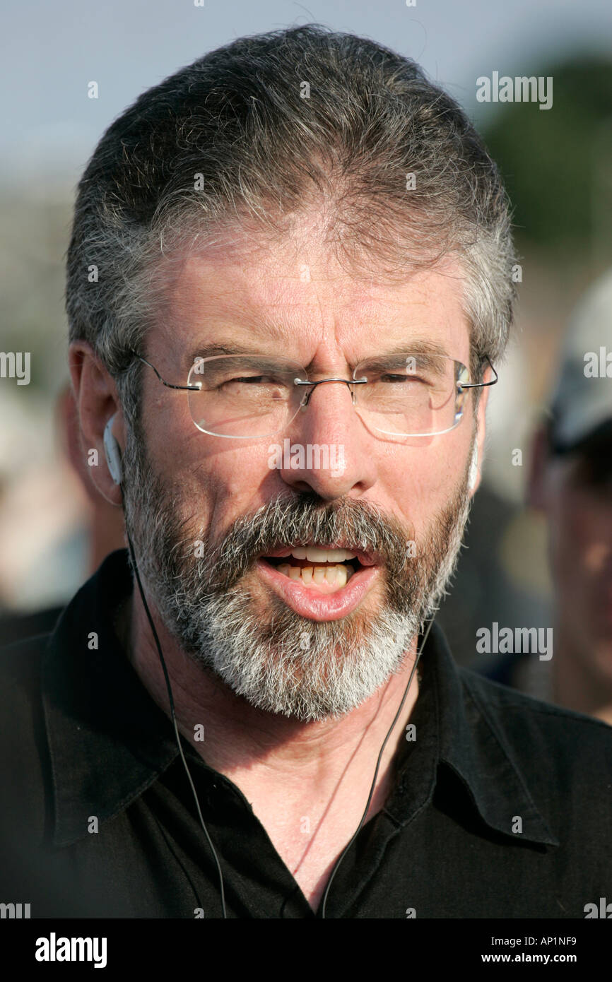 Sinn Fein former president  former MP and former MLA TD Gerry Adams with mobile headphones on crumlin road at ardoyne shops Stock Photo