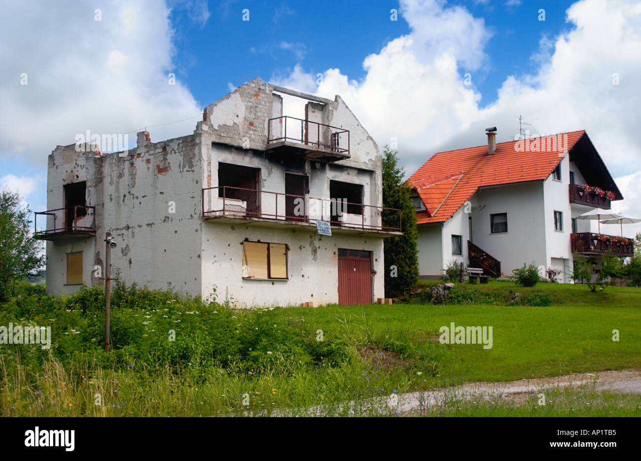 Destruction and construction A shelled and burned off house during the war in Croatia Yugoslavia and a newly build house Stock Photo