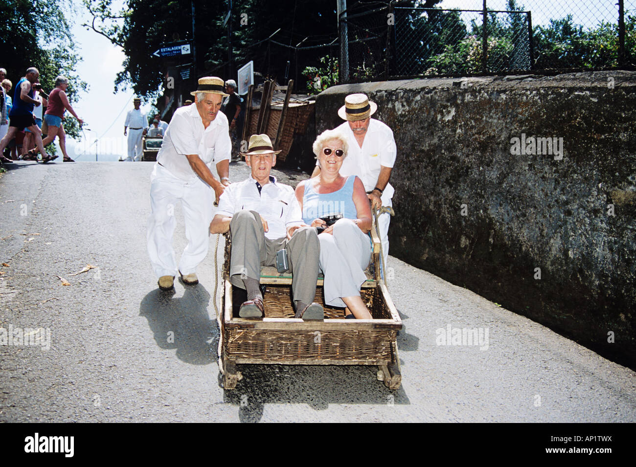 Tourists in Monte toboggan ride, Monte, near Funchal, Madeira Stock
