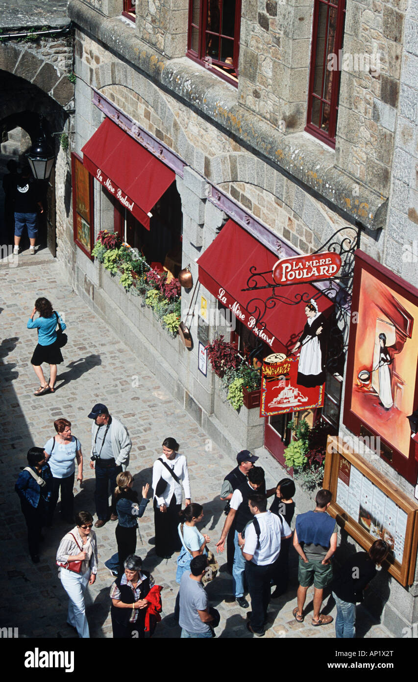 Tourists walking outside La Mere Poulard Restaurant, Le Mont Saint Michel, Normandy, France Stock Photo