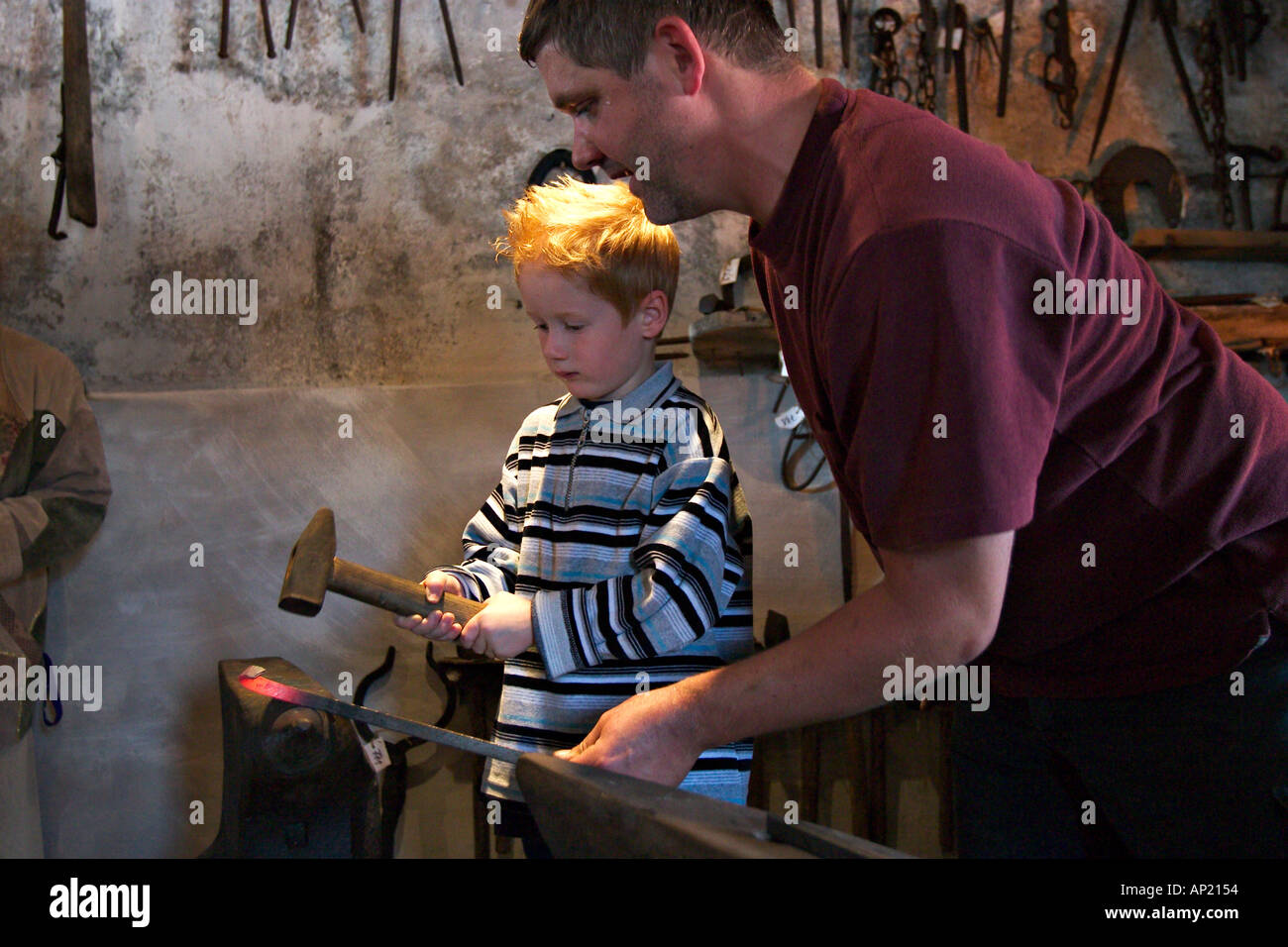 blacksmith teaches a child Stock Photo