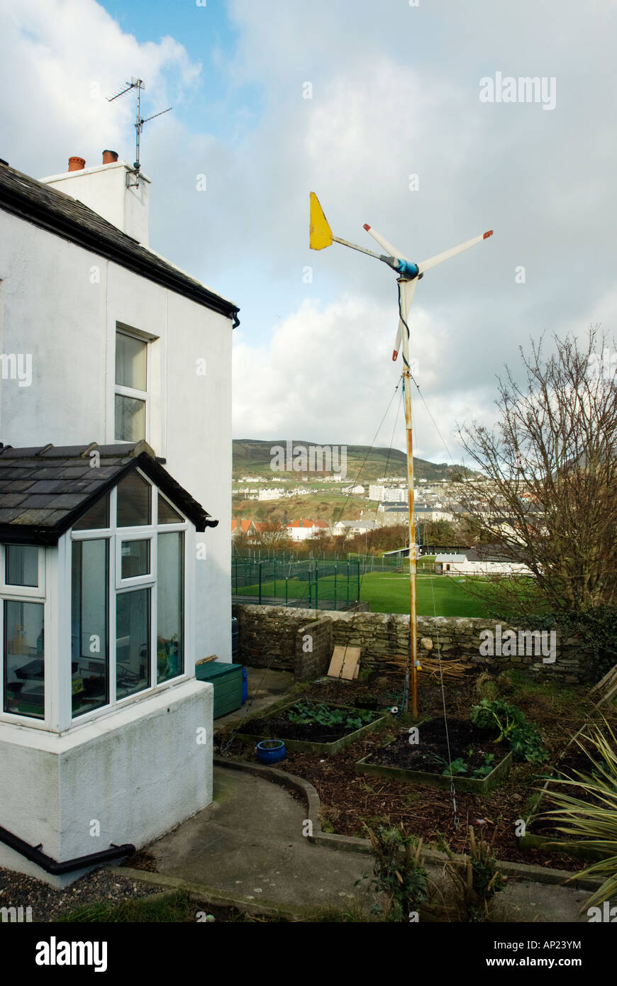 Wind turbine in garden of house Stock Photo