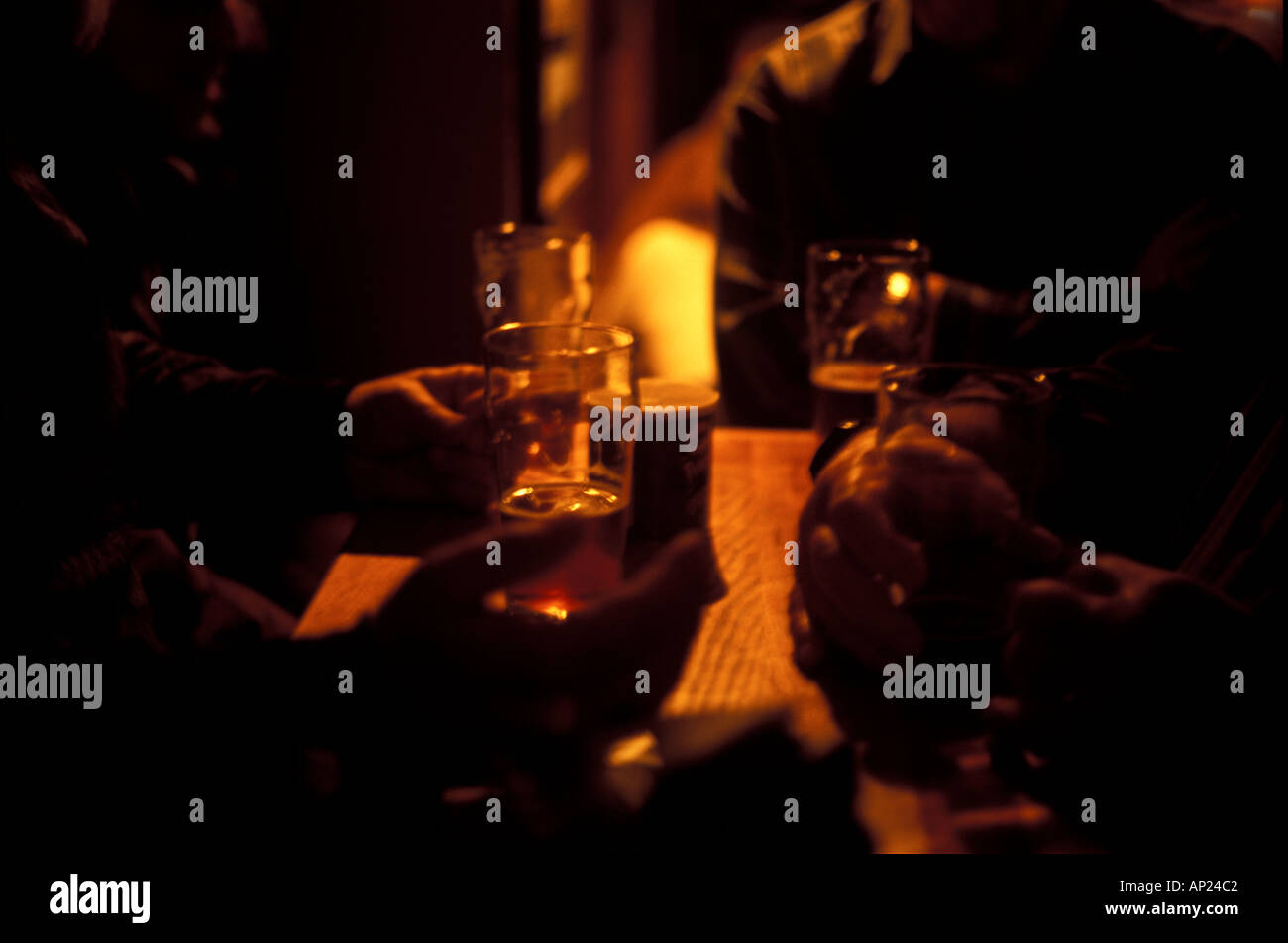 drinking beer in a small pub in dim light Stock Photo