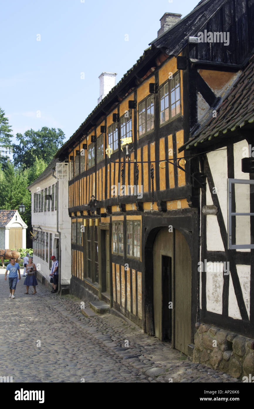 Cobbled street with orange half-timbered building in the Old Town Museum Den Gamle By, Arhus Denmark Stock Photo