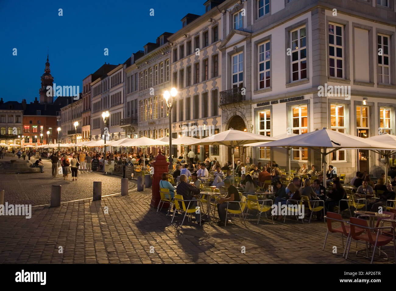 People drinking and eating outdoors at bars and restaurants in street