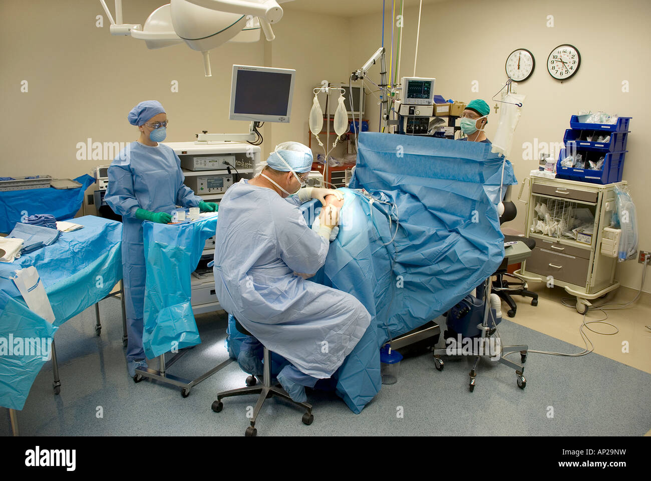 Surgical team performing arthroscopic knee surgery in hospital
