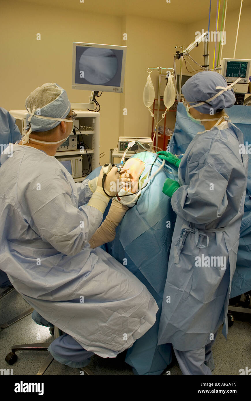 Surgical team performing arthroscopic knee surgery in hospital operating room Stock Photo