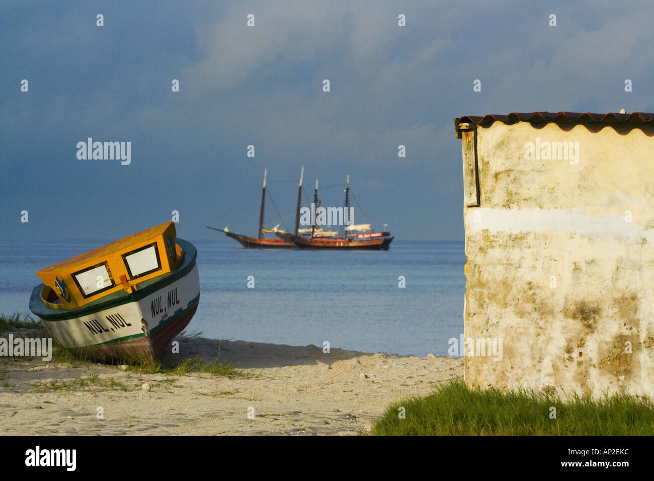 Boat on beach with sail boats just off shore in background Aruba Hadicurari Stock Photo