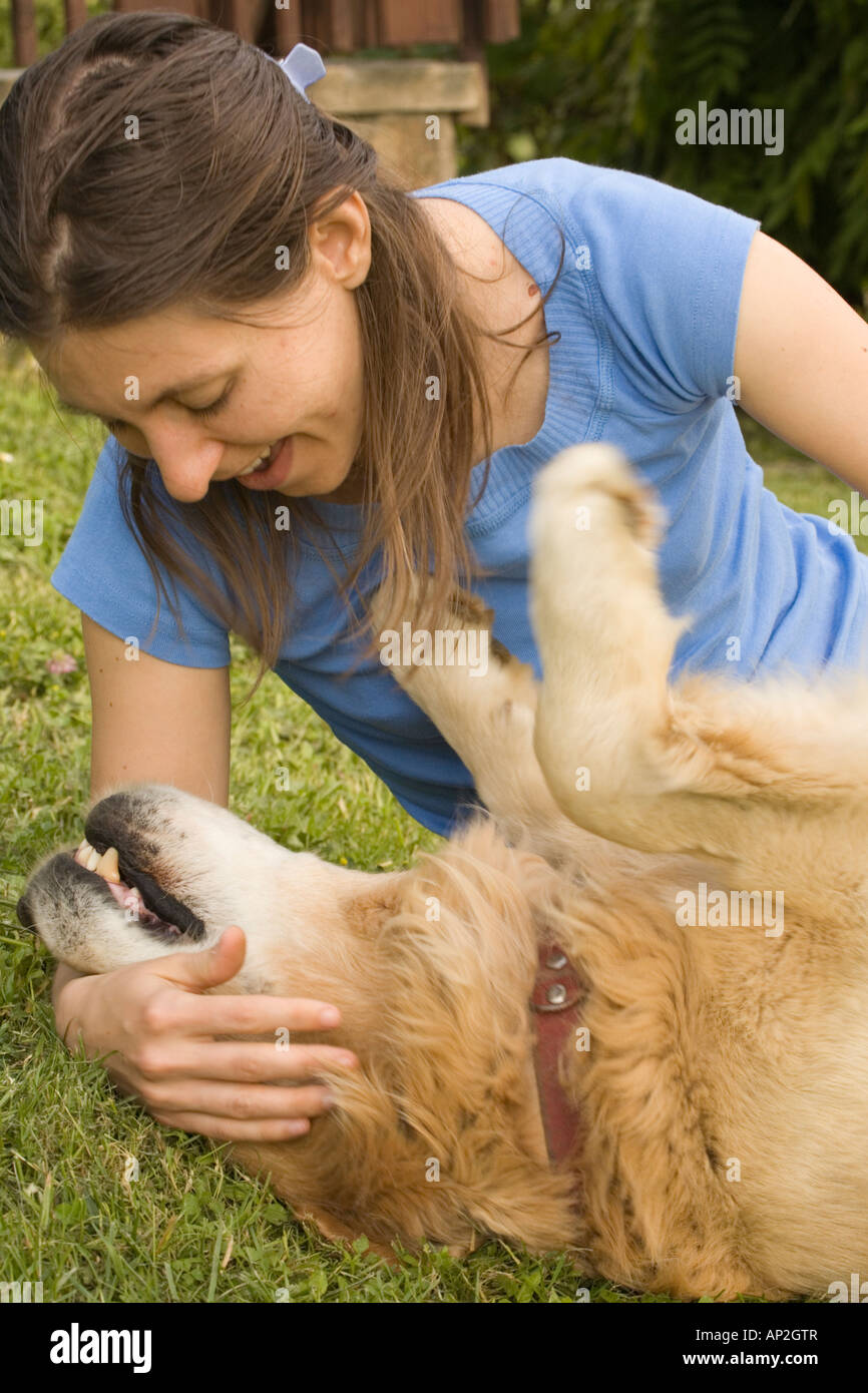 Girl petting golden retriever Slovenia Stock Photo - Alamy