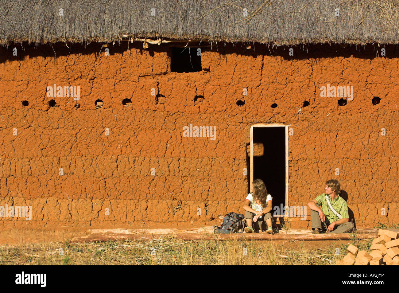 Two hikers having a rest at a typical hut, Madagascar, Africa Stock Photo