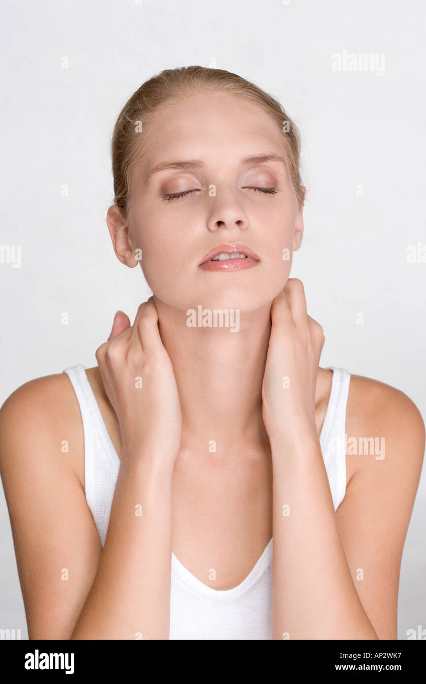 young woman massaging her nape Stock Photo Alamy