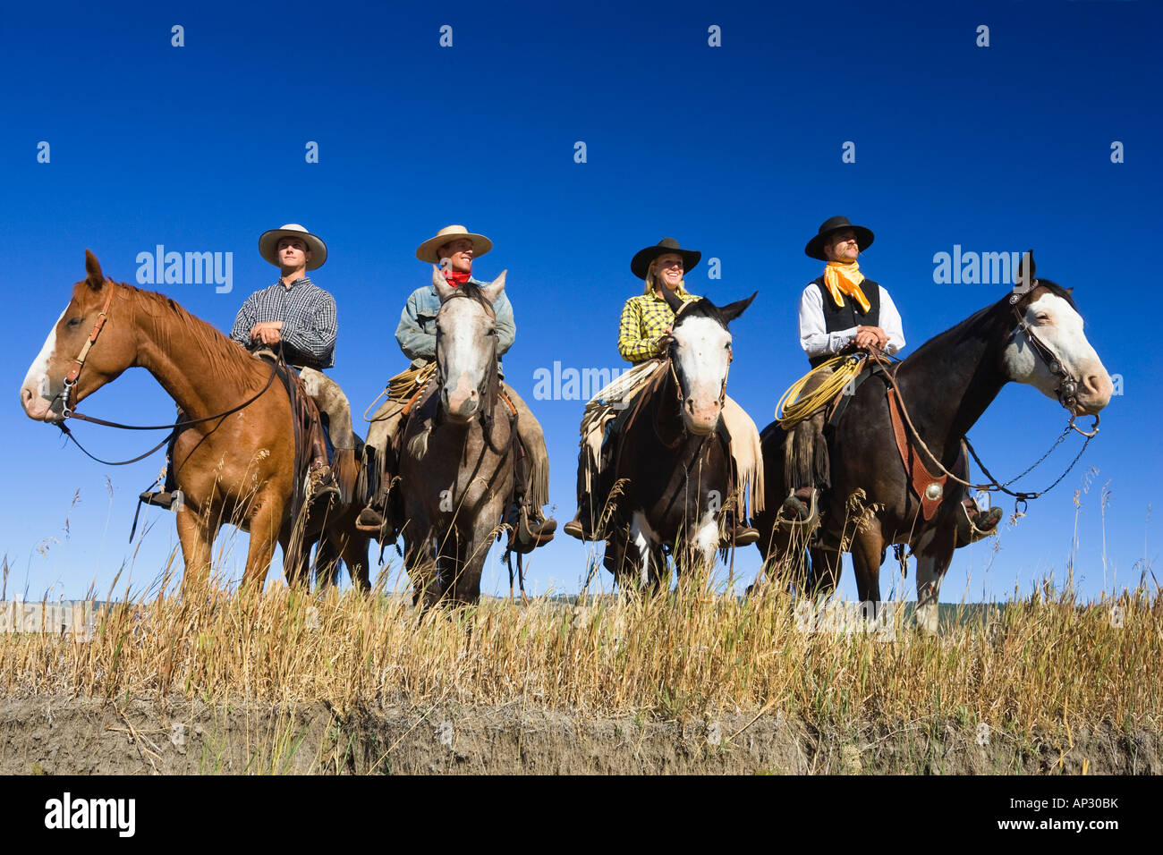 Four riding cowboys hi-res stock photography and images - Alamy