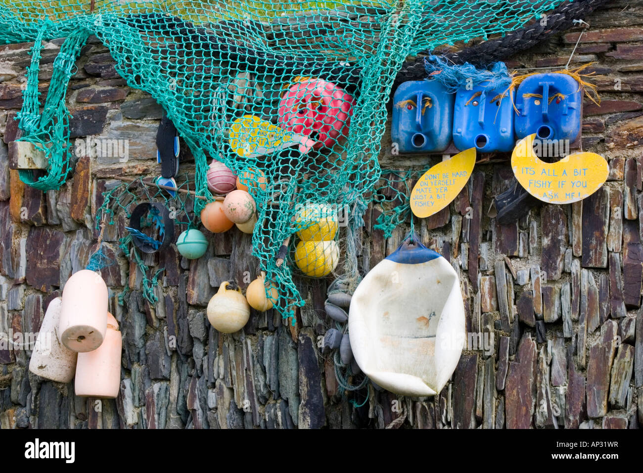 https://c8.alamy.com/comp/AP31WR/beach-art-made-from-old-fishing-nets-fishing-buoys-and-plastic-containers-AP31WR.jpg