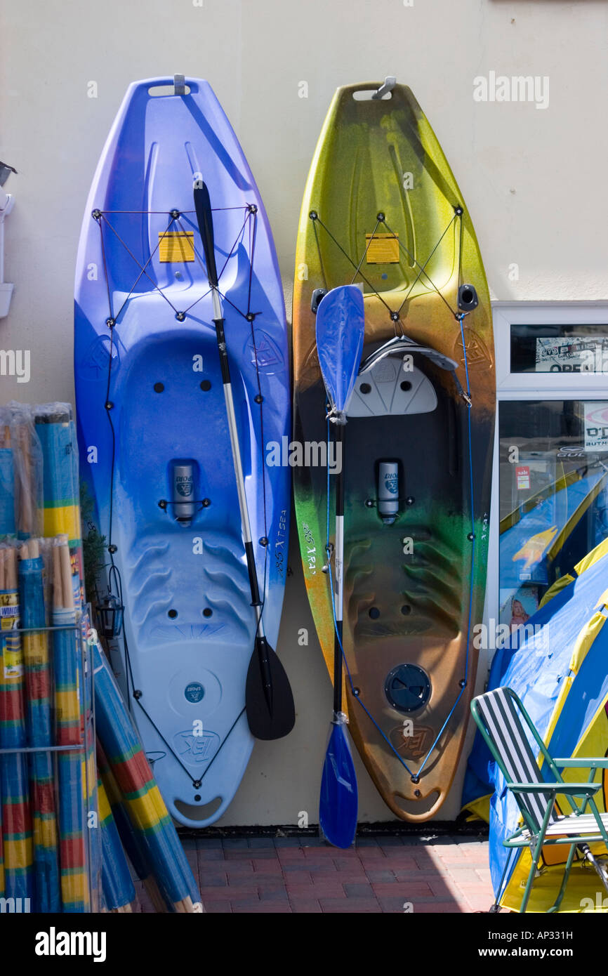 Sea Kayaks for sale outside a beach goods shop Stock Photo Alamy