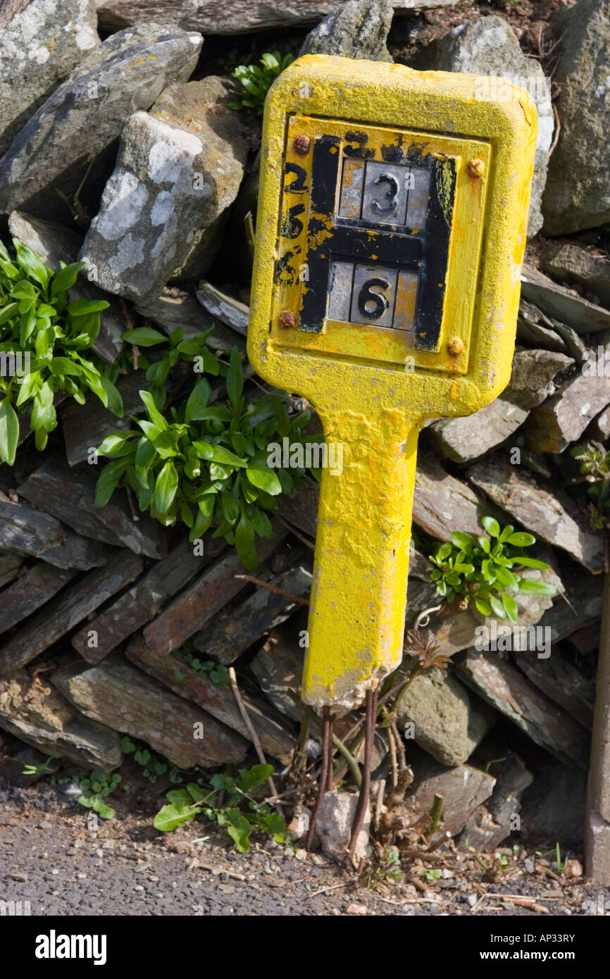 Yellow concrete water main marker Stock Photo Alamy