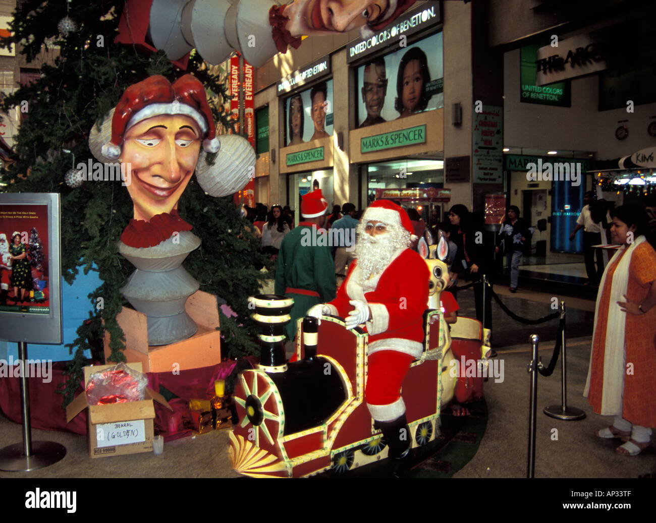 Indian Santa Claus on toy train in shopping centre at Christmas, Mumbai