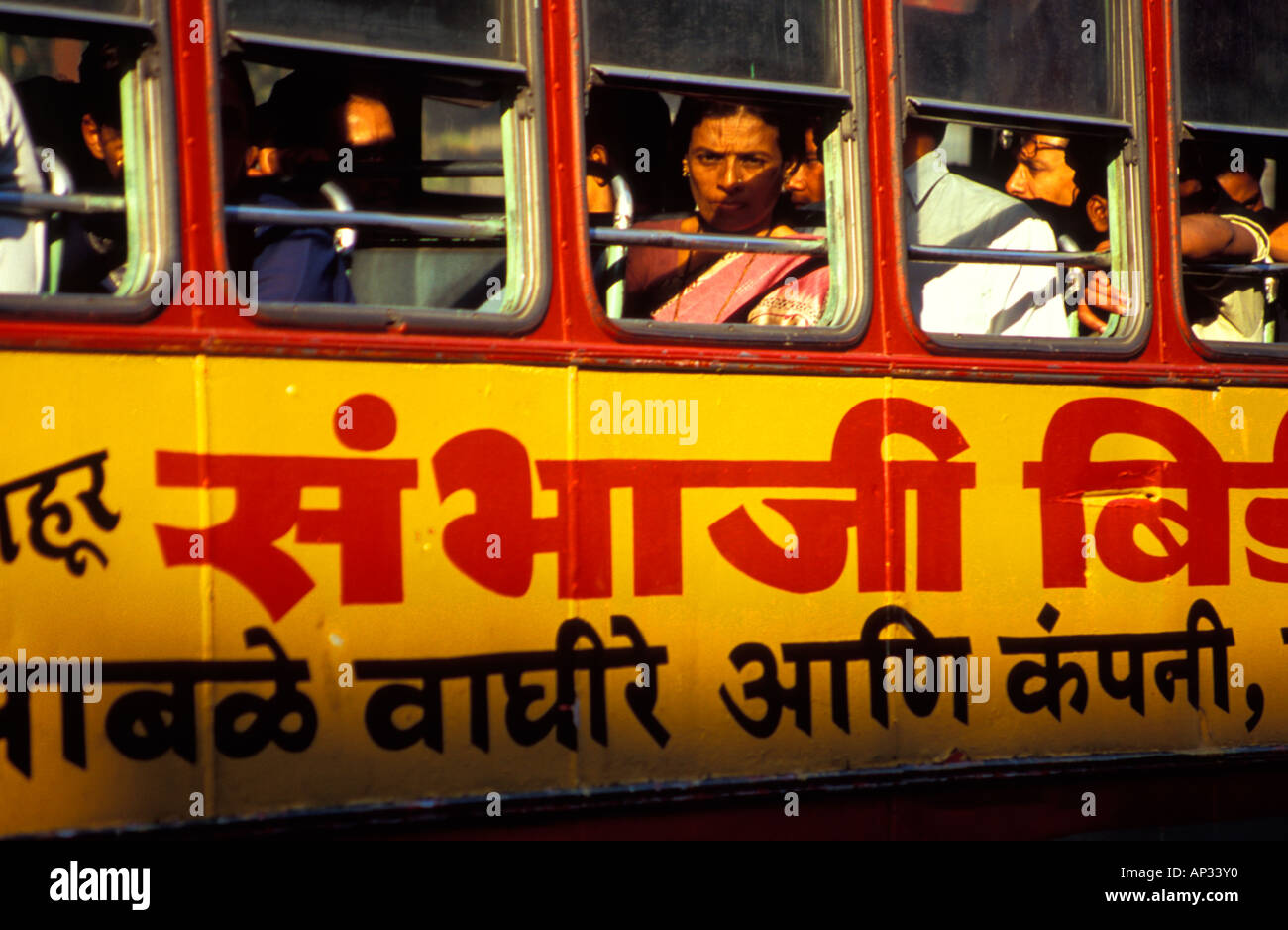 Indian bus passengers seated beside window of bus, Mumbai, South India Stock Photo