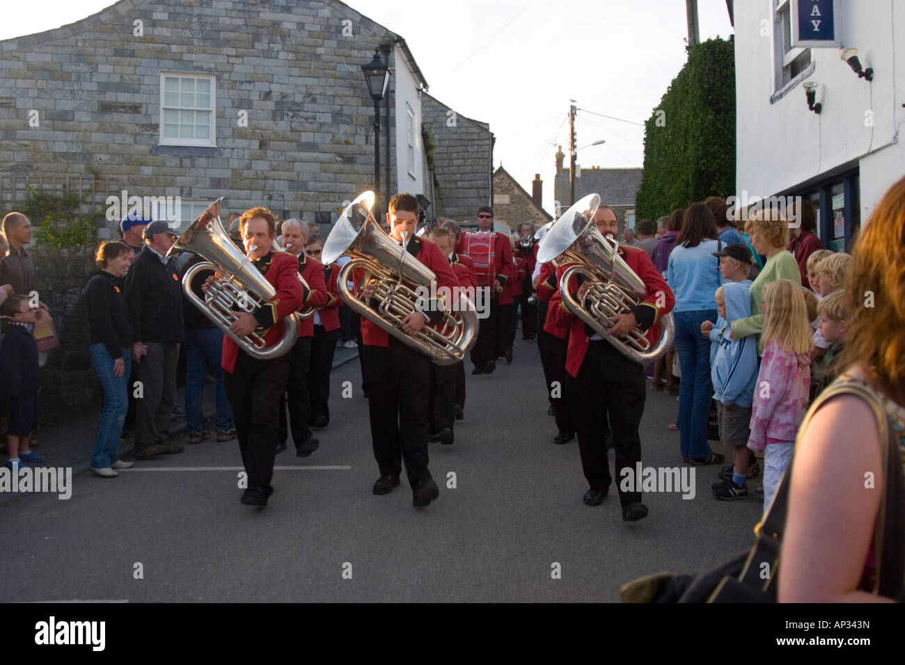 Brass band playing and marching in the streets of Port Isaac Cornwall