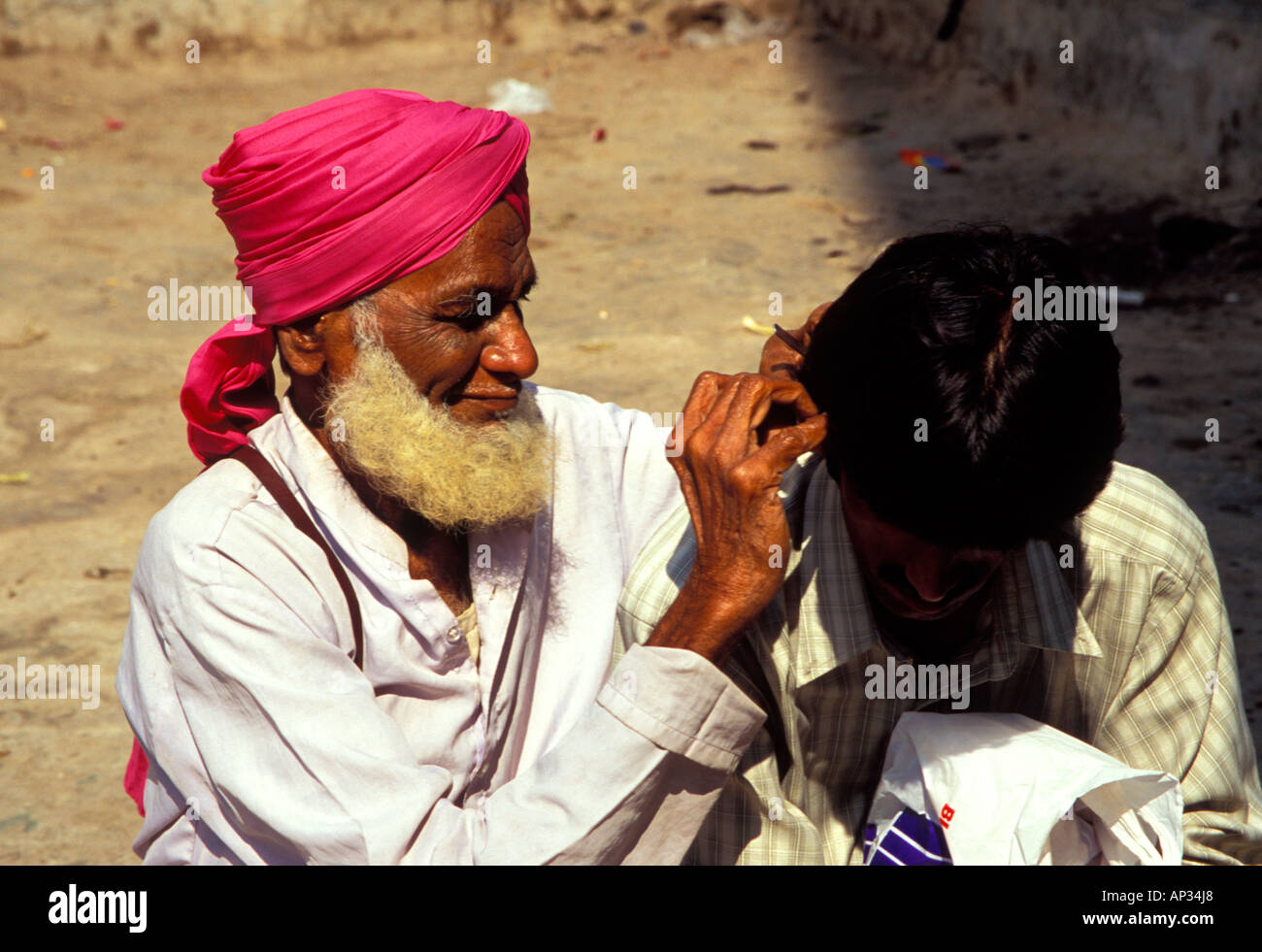 Indian Ear Cleaner working on someone's ear wax, Mumbai, South India